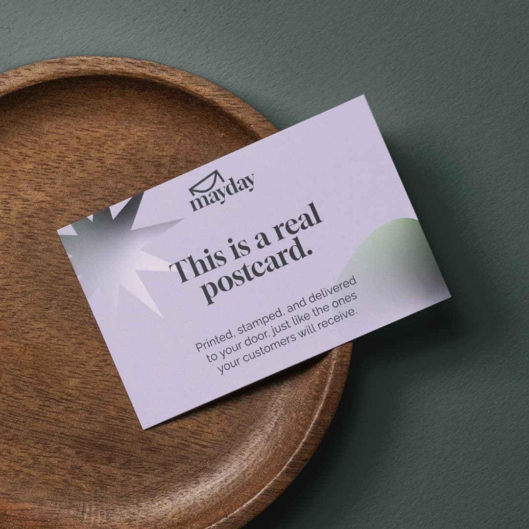 A branded e-commerce postcard flat-lay on warm linen